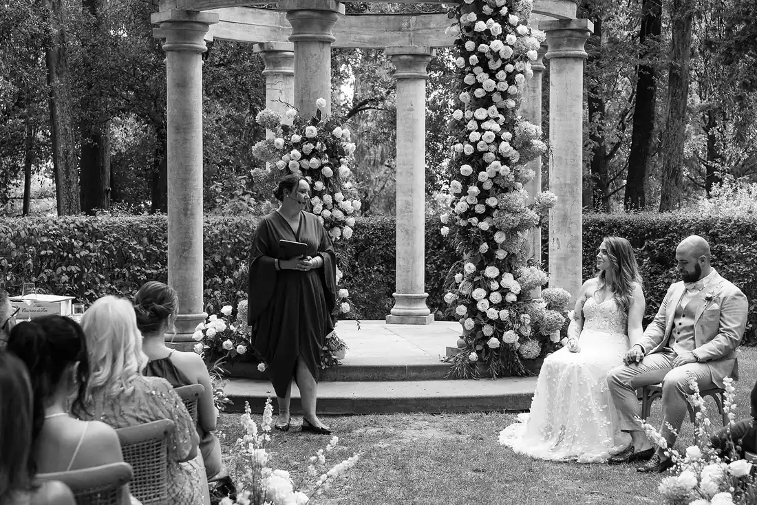 Wedding ceremony between columns with a floral arch